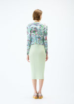 A model wears the PLEATS PLEASE ISSEY MIYAKE LIGHT FESTIVAL cardigan.