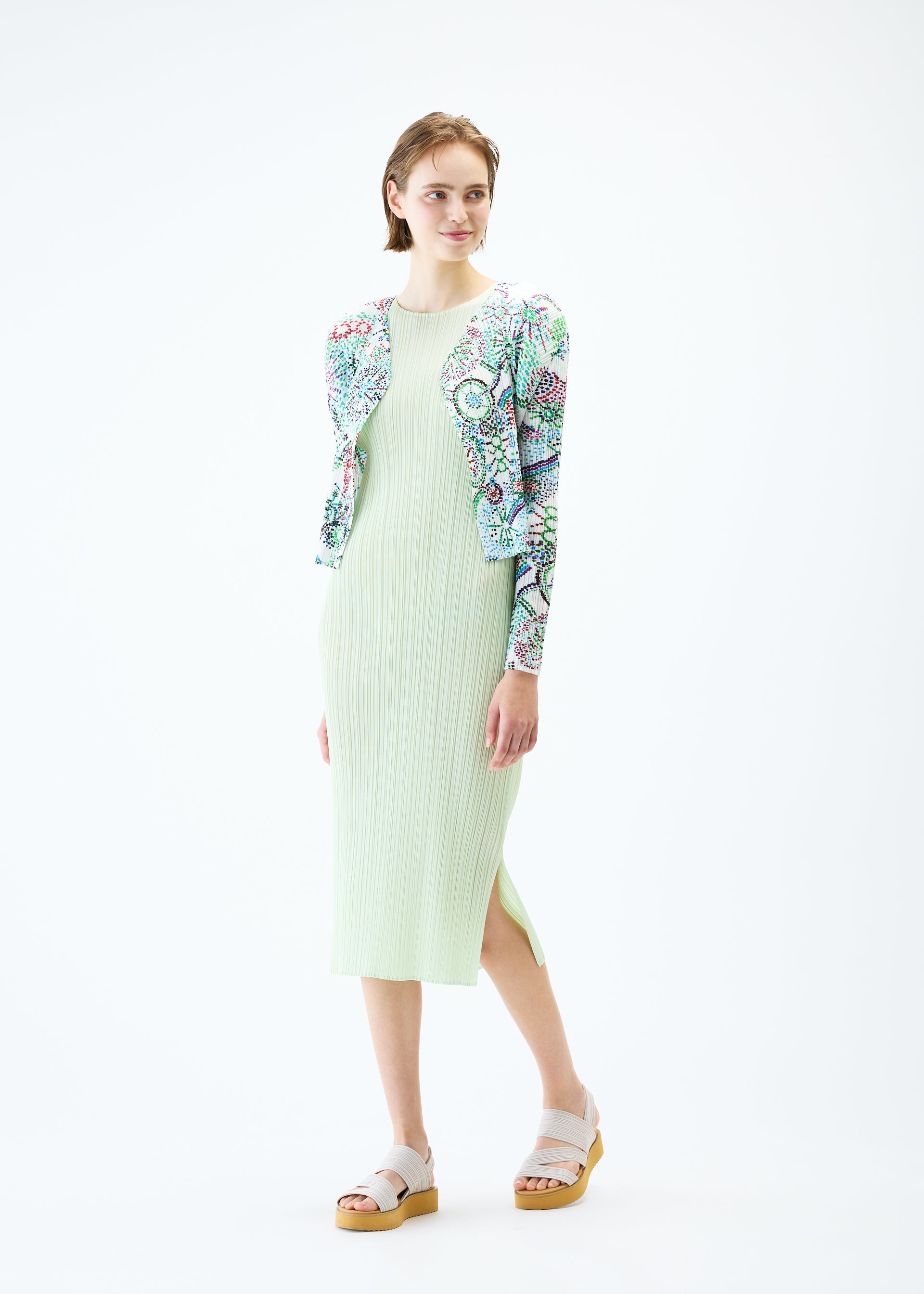 A model wears the PLEATS PLEASE ISSEY MIYAKE LIGHT FESTIVAL cardigan.