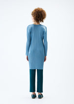 A model wears the PLEATS PLEASE ISSEY MIYAKE MONTHLY COLORS JANUARY tunic.