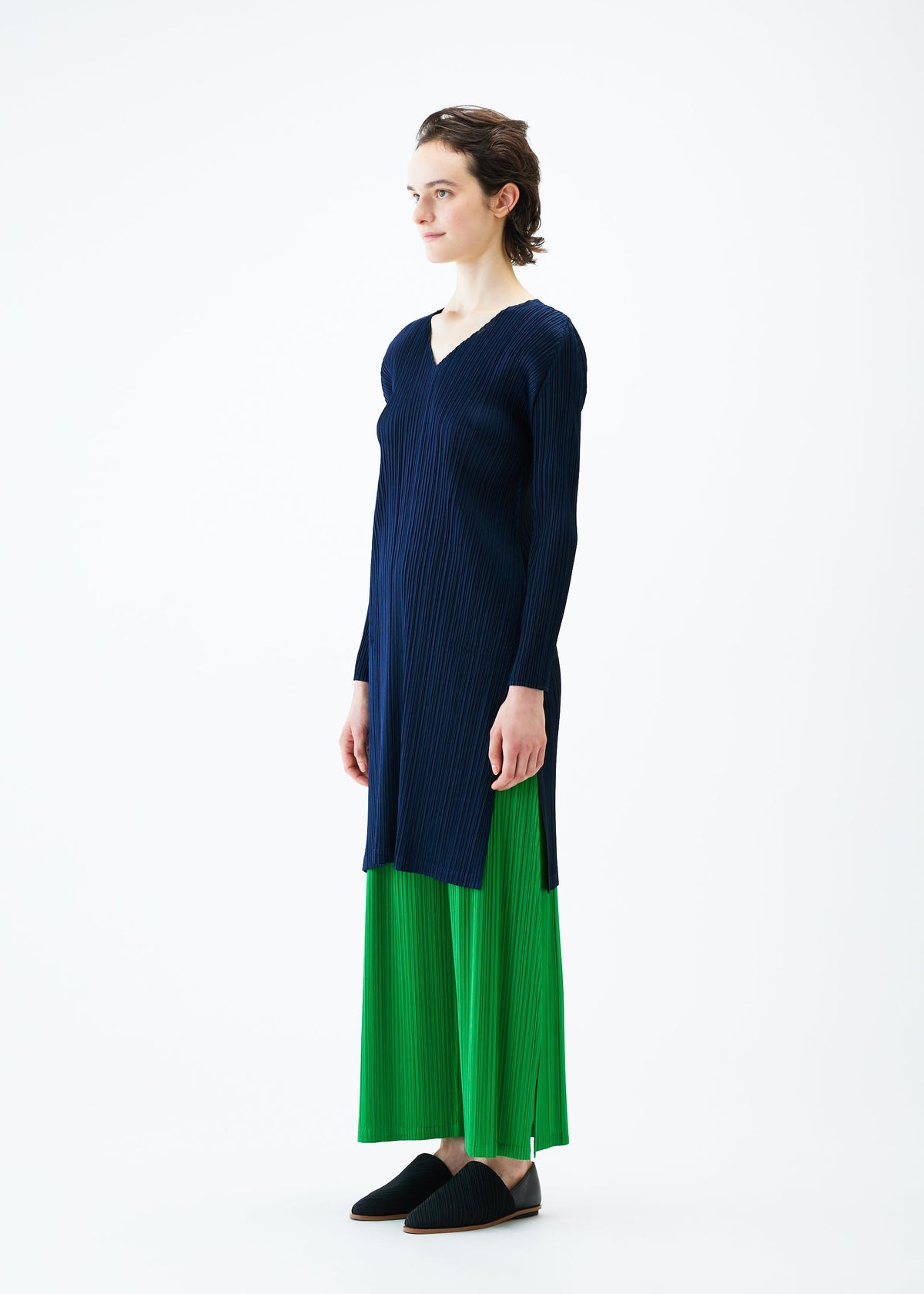 A model wears the PLEATS PLEASE ISSEY MIYAKE MONTHLY COLORS FEBRUARY tunic.