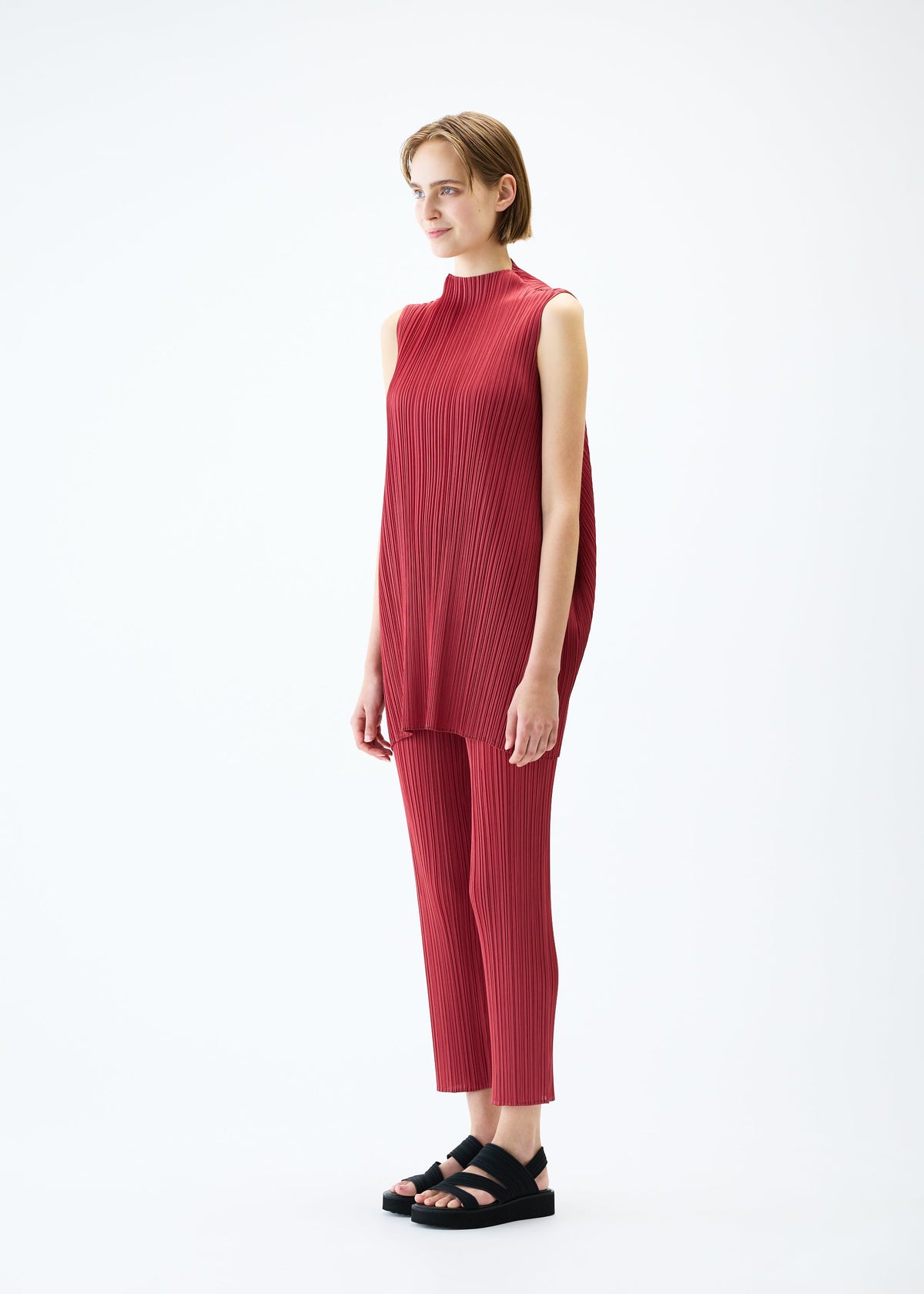 A model wears the PLEATS PLEASE ISSEY MIYAKE LAMP SHADE tunic.