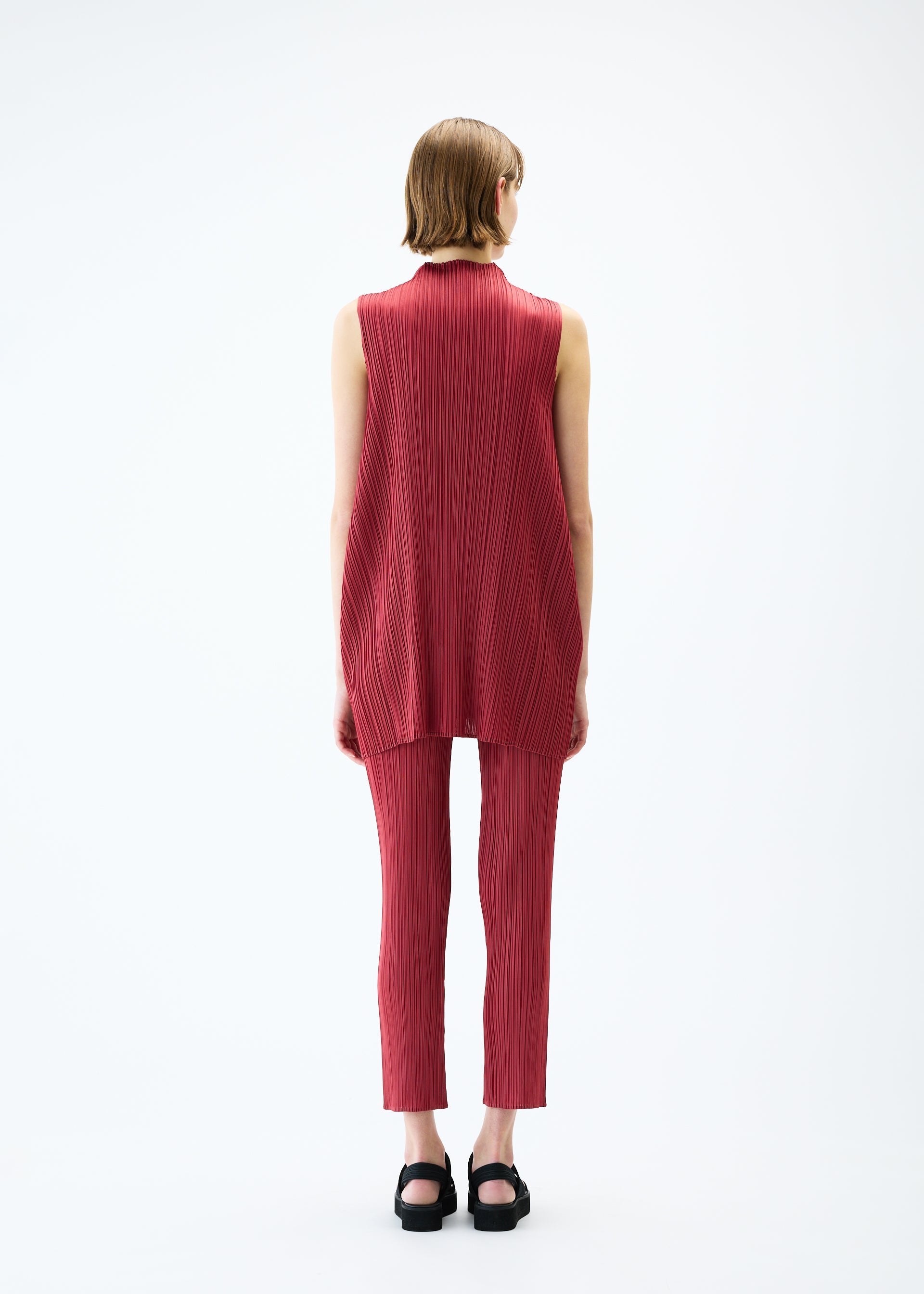 A model wears the PLEATS PLEASE ISSEY MIYAKE LAMP SHADE tunic.