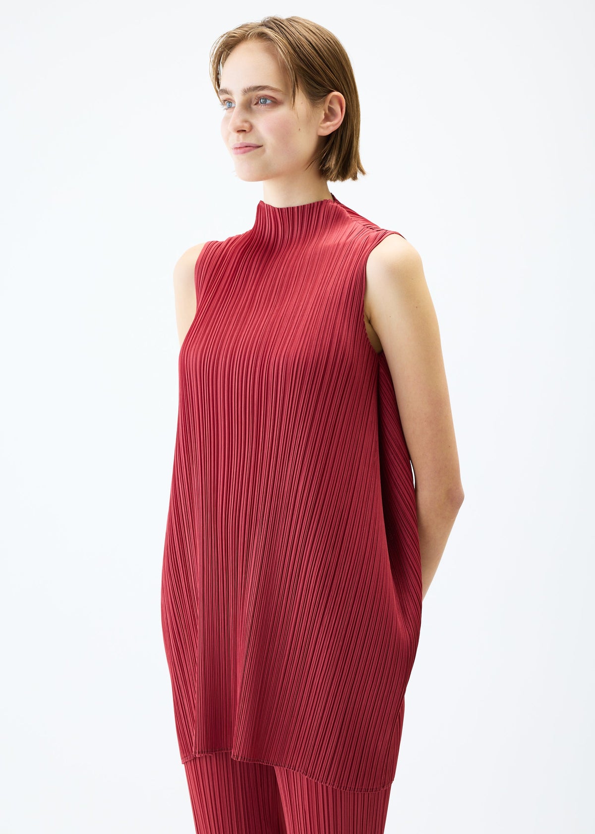 A model wears the PLEATS PLEASE ISSEY MIYAKE LAMP SHADE tunic.