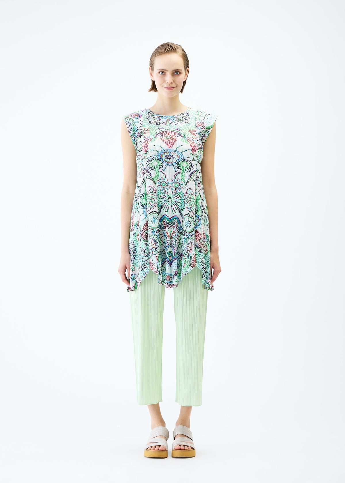 A model wears the PLEATS PLEASE ISSEY MIYAKE LIGHT FESTIVAL tunic.
