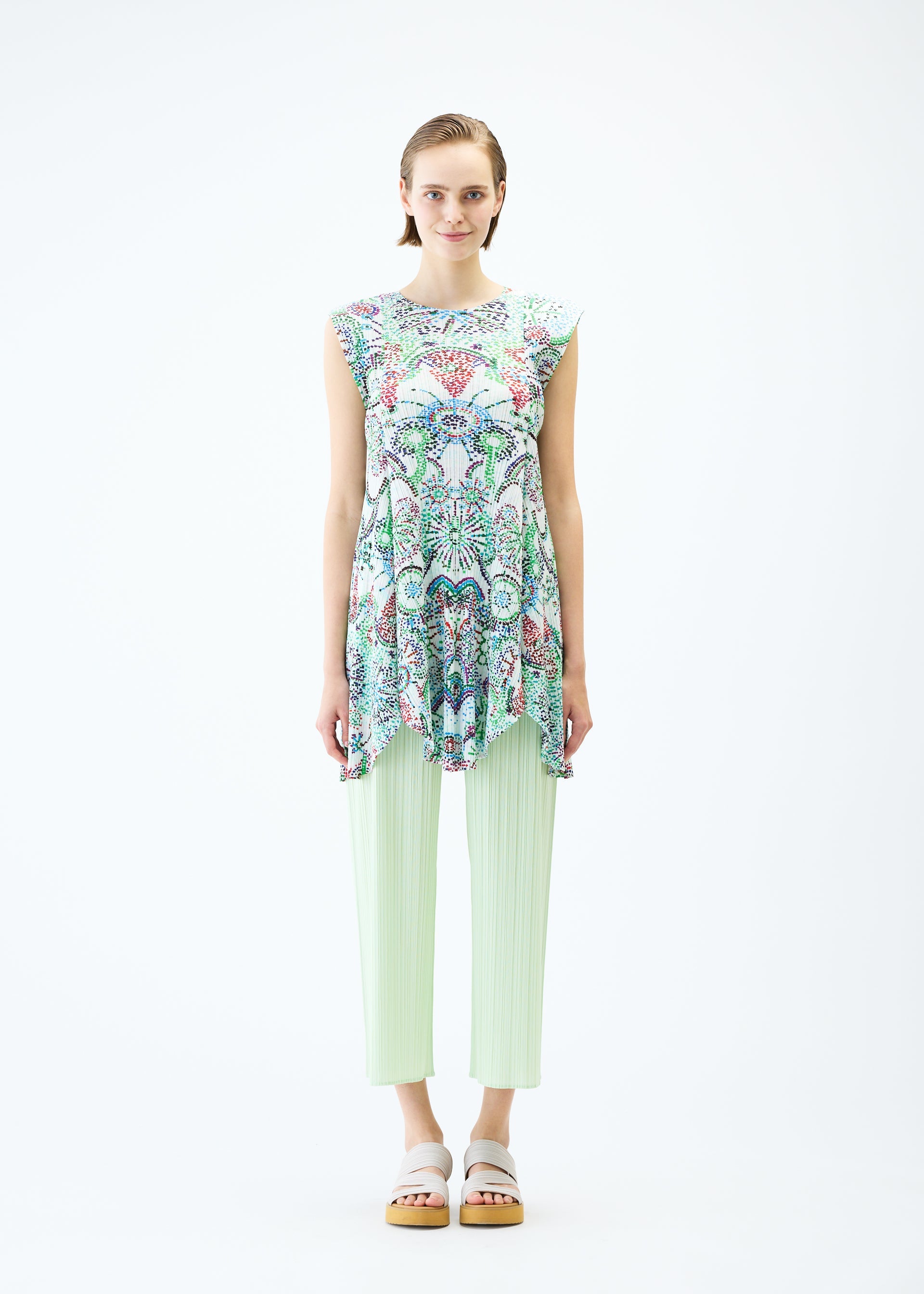 A model wears the PLEATS PLEASE ISSEY MIYAKE LIGHT FESTIVAL tunic.