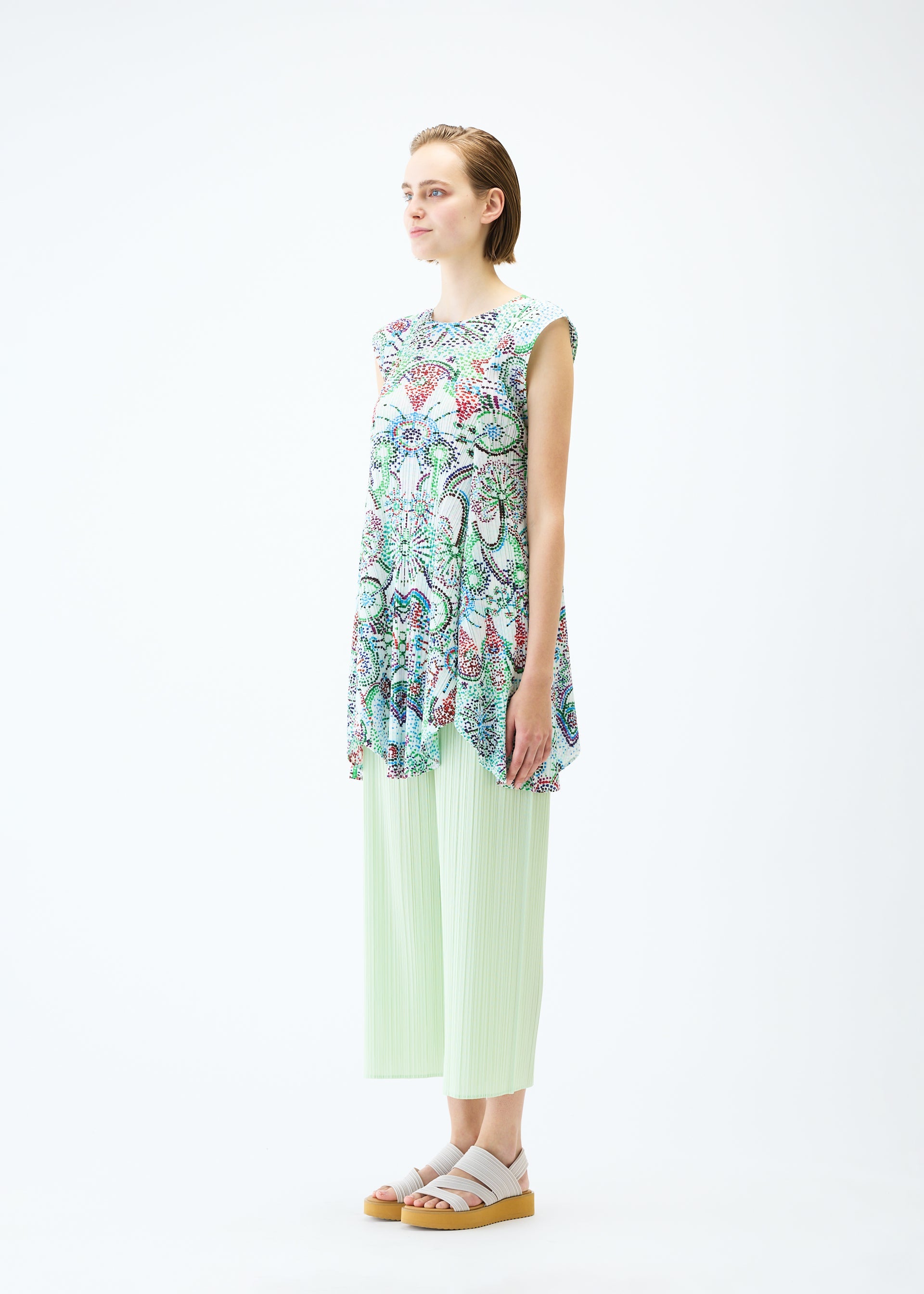 A model wears the PLEATS PLEASE ISSEY MIYAKE LIGHT FESTIVAL tunic.