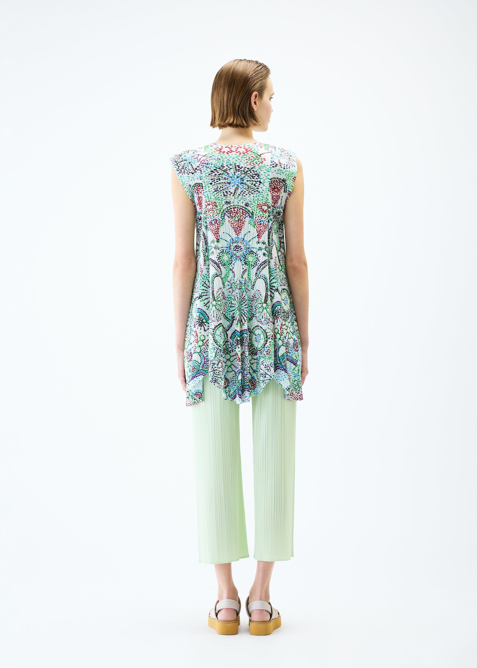 A model wears the PLEATS PLEASE ISSEY MIYAKE LIGHT FESTIVAL tunic.