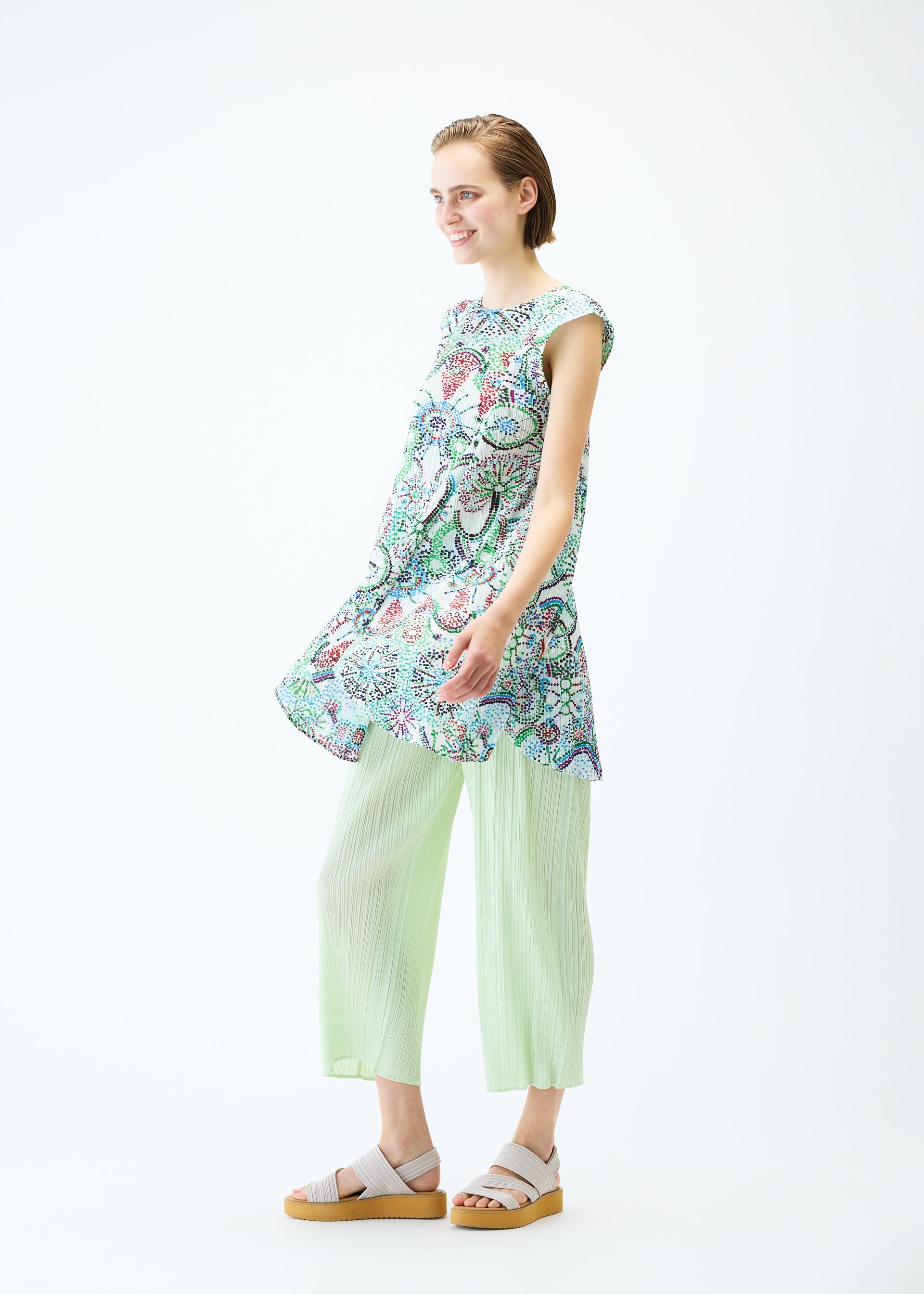 A model wears the PLEATS PLEASE ISSEY MIYAKE LIGHT FESTIVAL tunic.