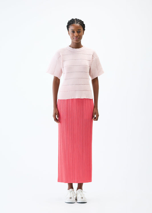 A model wears the PLEATS PLEASE ISSEY MIYAKE JIGGLY KNIT top.