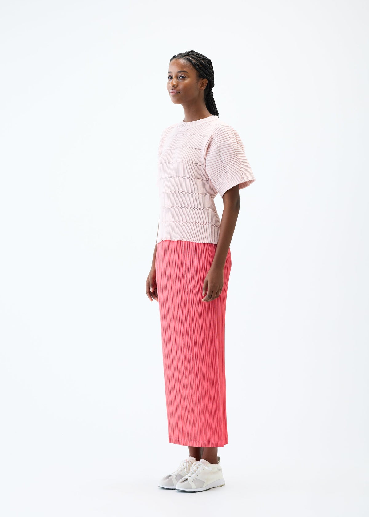 A model wears the PLEATS PLEASE ISSEY MIYAKE JIGGLY KNIT top.