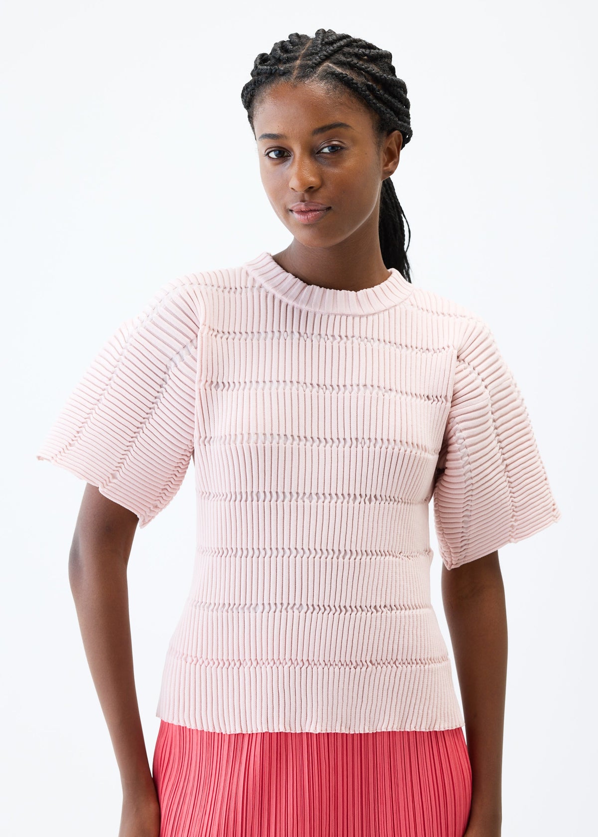 A model wears the PLEATS PLEASE ISSEY MIYAKE JIGGLY KNIT top.