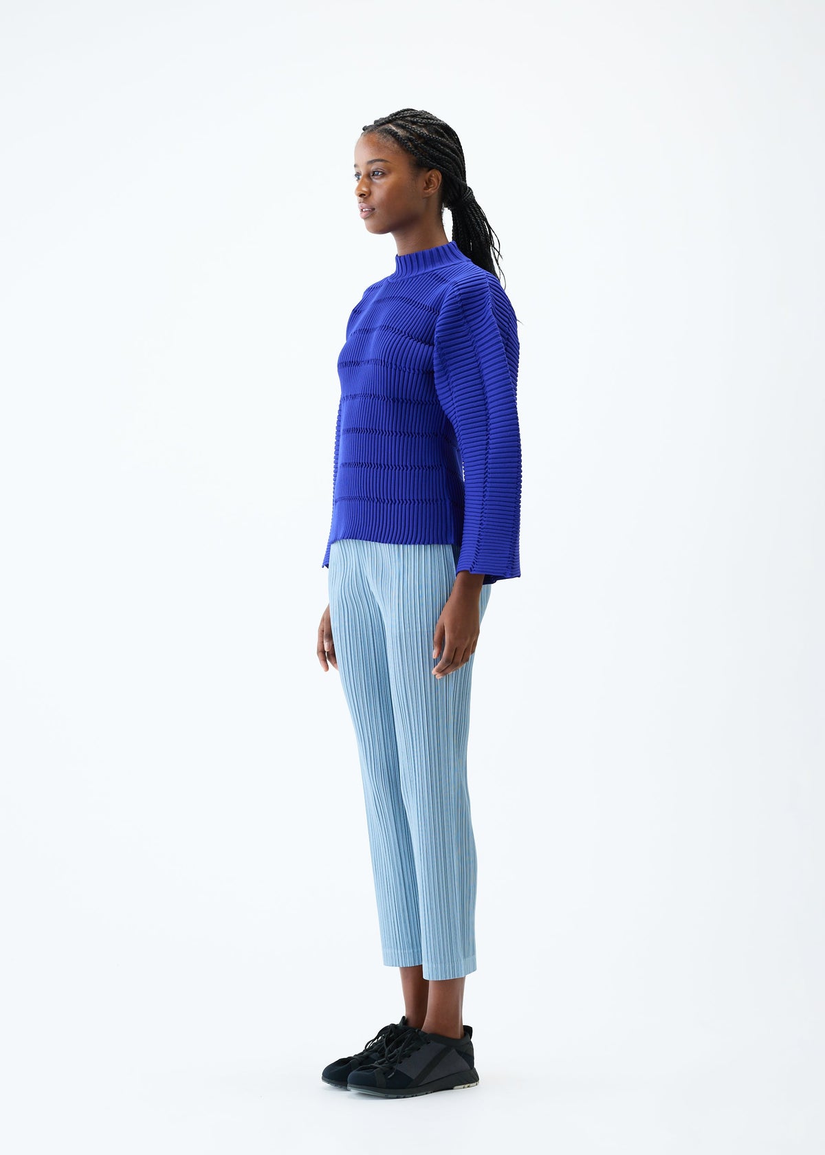 A model wears the PLEATS PLEASE ISSEY MIYAKE JIGGLY KNIT top.