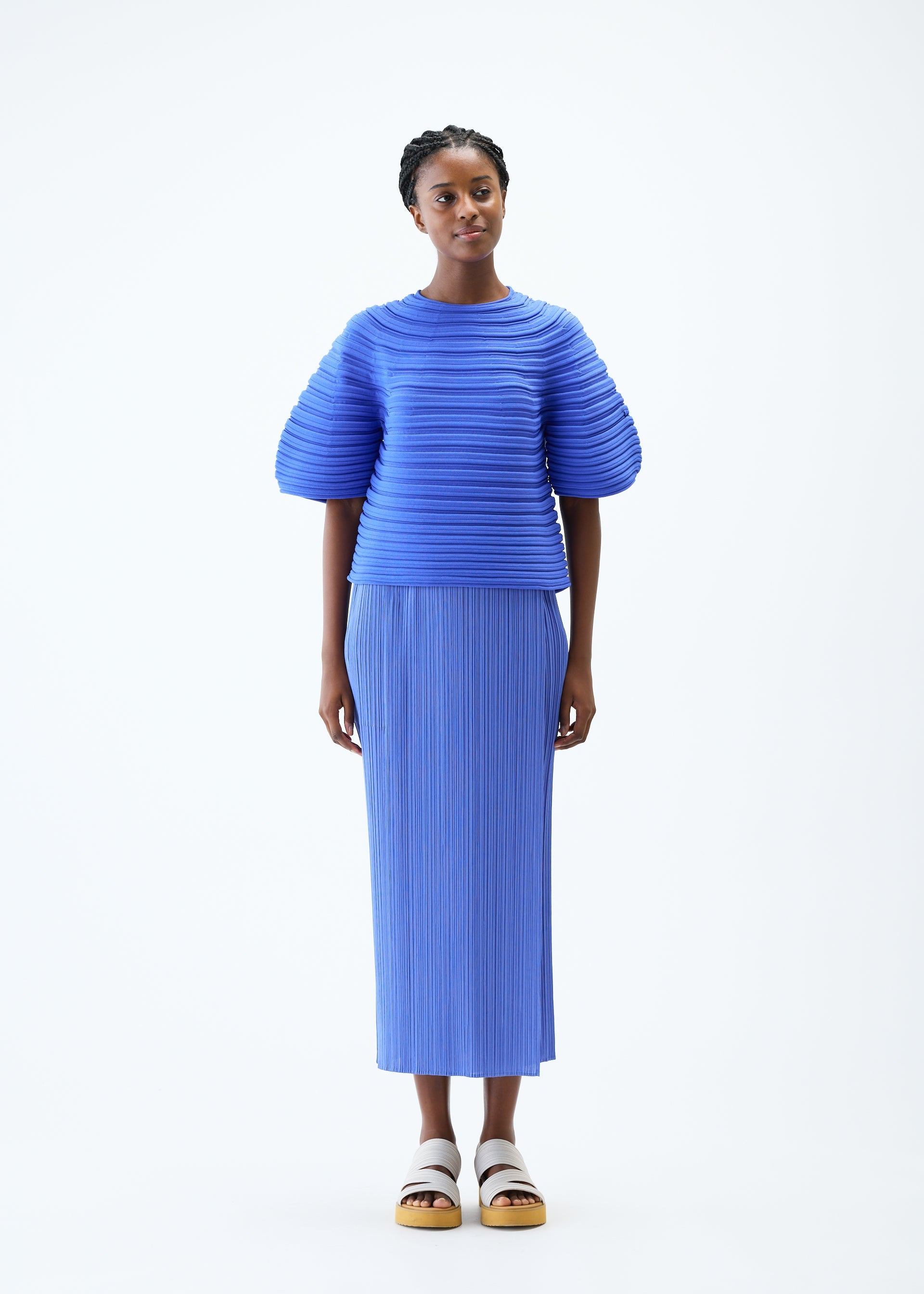 A model wears the PLEATS PLEASE ISSEY MIYAKE MUSHROOM KNIT top.