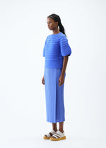 A model wears the PLEATS PLEASE ISSEY MIYAKE MUSHROOM KNIT top.