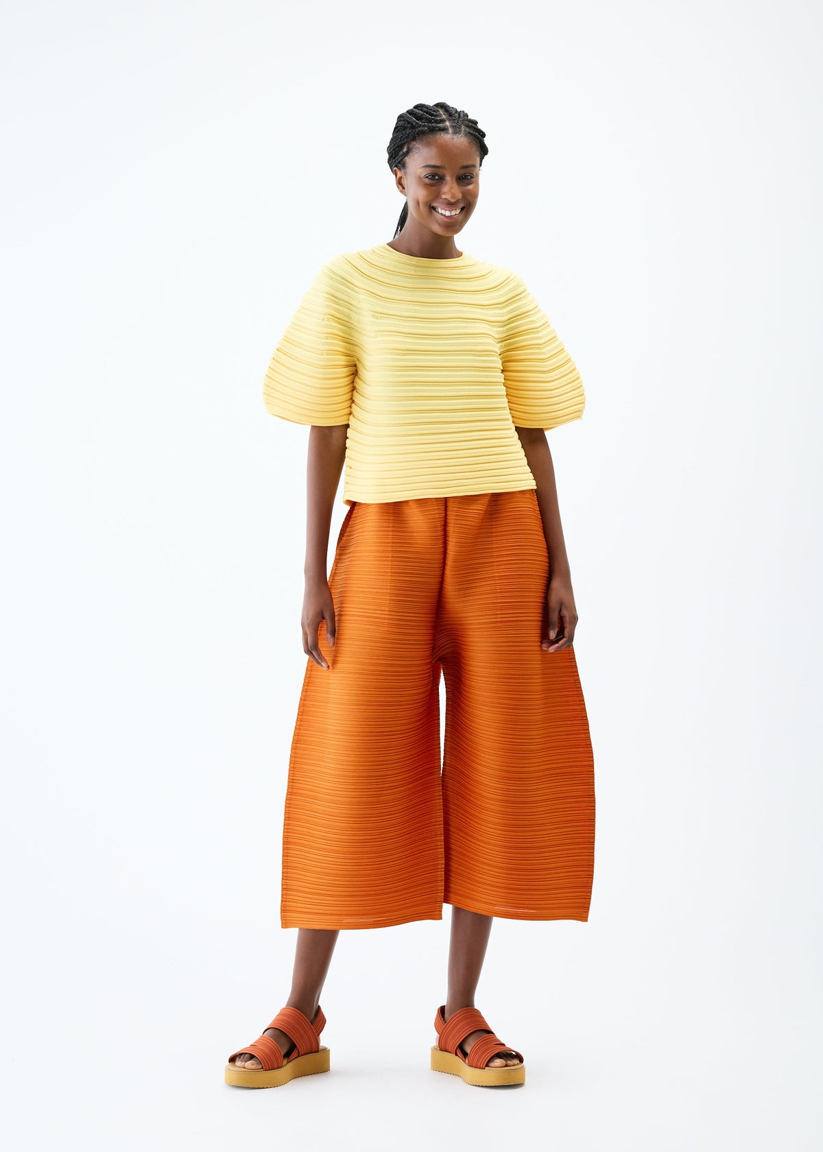 A model wears the PLEATS PLEASE ISSEY MIYAKE MUSHROOM KNIT top.