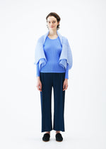 A model wears the PLEATS PLEASE ISSEY MIYAKE ZIGZAG PLEATS SCARF stole.