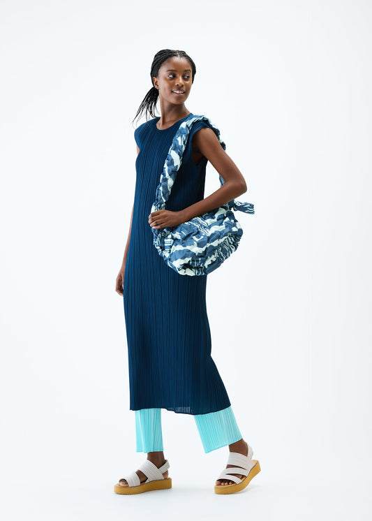 A model wears the PLEATS PLEASE ISSEY MIYAKE REFRACTION FLUFFY BAG bag.