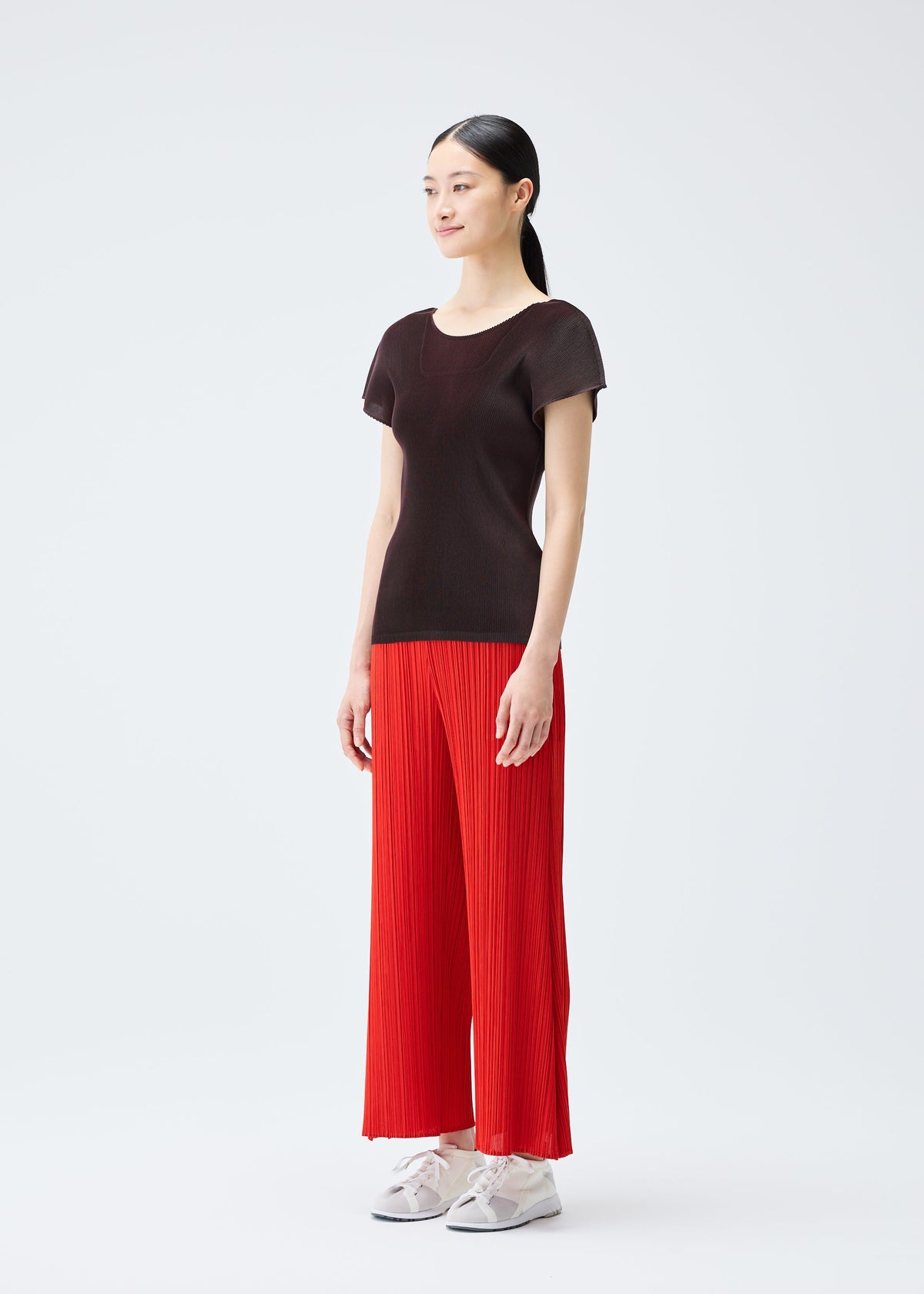 A model wears the PLEATS PLEASE ISSEY MIYAKE MIST JULY top.