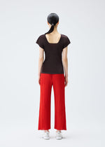 A model wears the PLEATS PLEASE ISSEY MIYAKE MIST JULY top.
