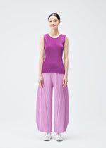 A model wears the PLEATS PLEASE ISSEY MIYAKE MIST SEPTEMBER top.