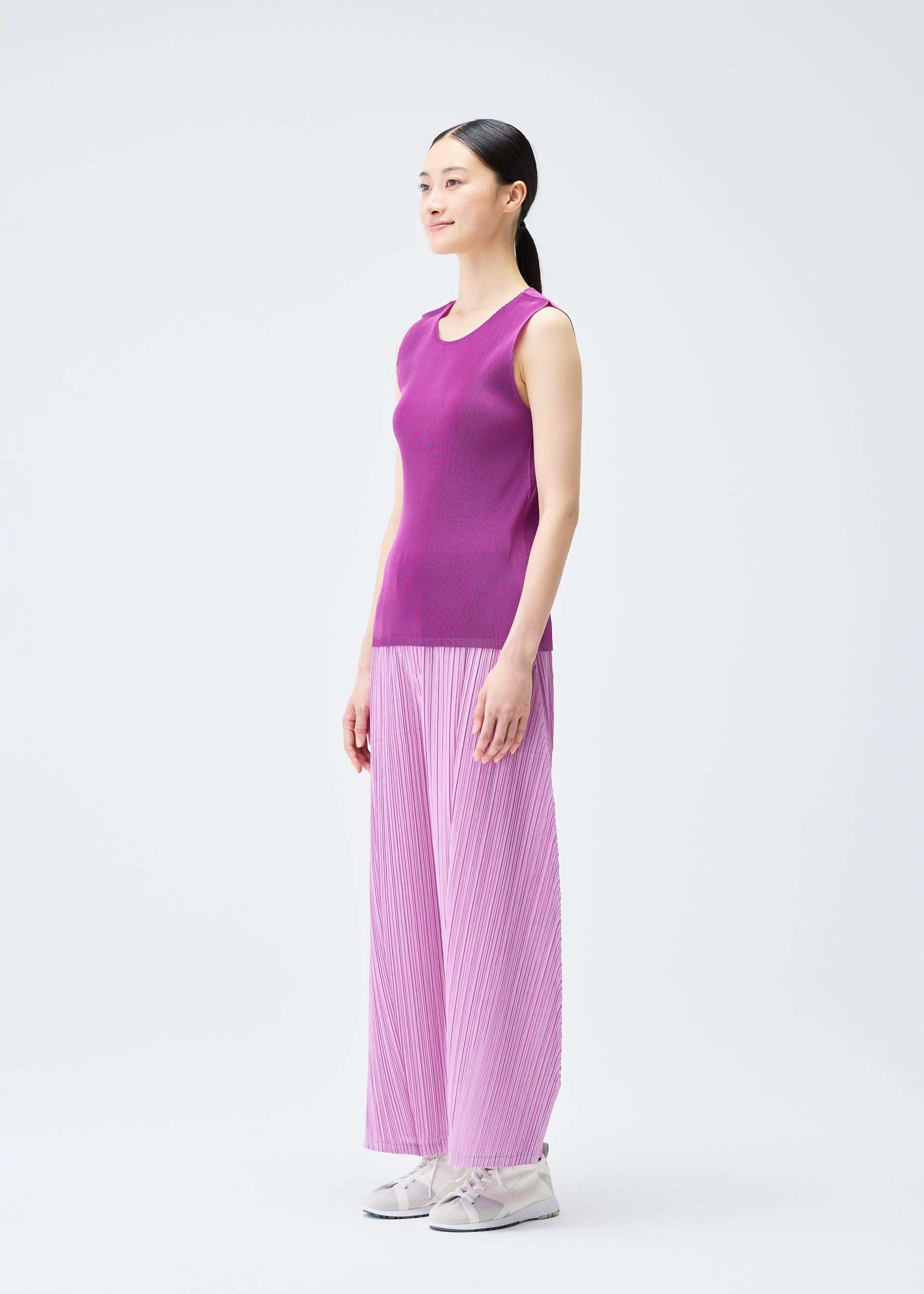 A model wears the PLEATS PLEASE ISSEY MIYAKE MIST SEPTEMBER top.