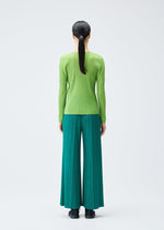 A model wears the PLEATS PLEASE ISSEY MIYAKE RIB PLEATS NOVEMBER top.