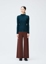 A model wears the PLEATS PLEASE ISSEY MIYAKE RIB PLEATS NOVEMBER top.