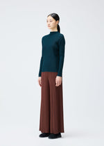 A model wears the PLEATS PLEASE ISSEY MIYAKE RIB PLEATS NOVEMBER top.