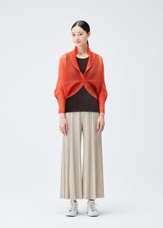 A model wears the PLEATS PLEASE ISSEY MIYAKE TATAMI JULY cardigan.