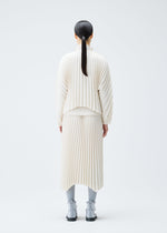 A model wears the PLEATS PLEASE ISSEY MIYAKE CIRCULAR cardigan.