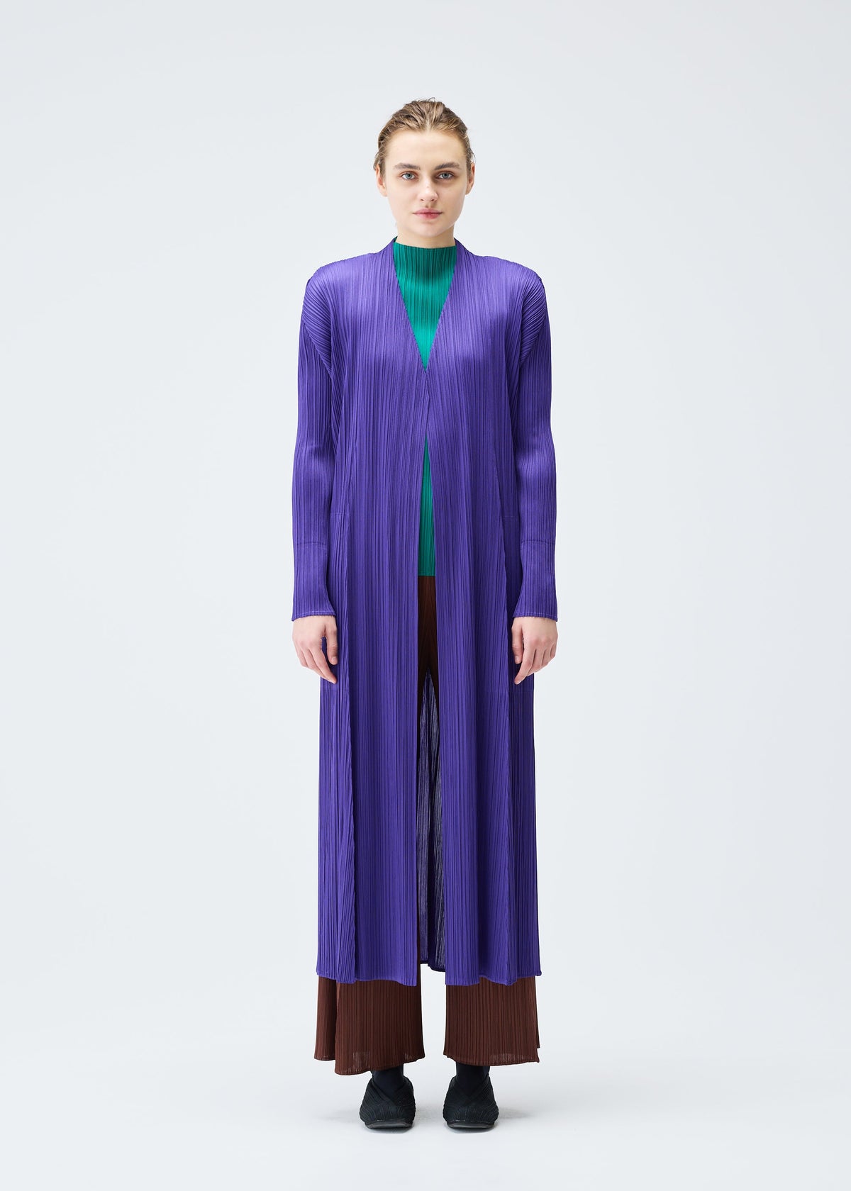 A model wears the PLEATS PLEASE ISSEY MIYAKE MONTHLY COLORS NOVEMBER coat.