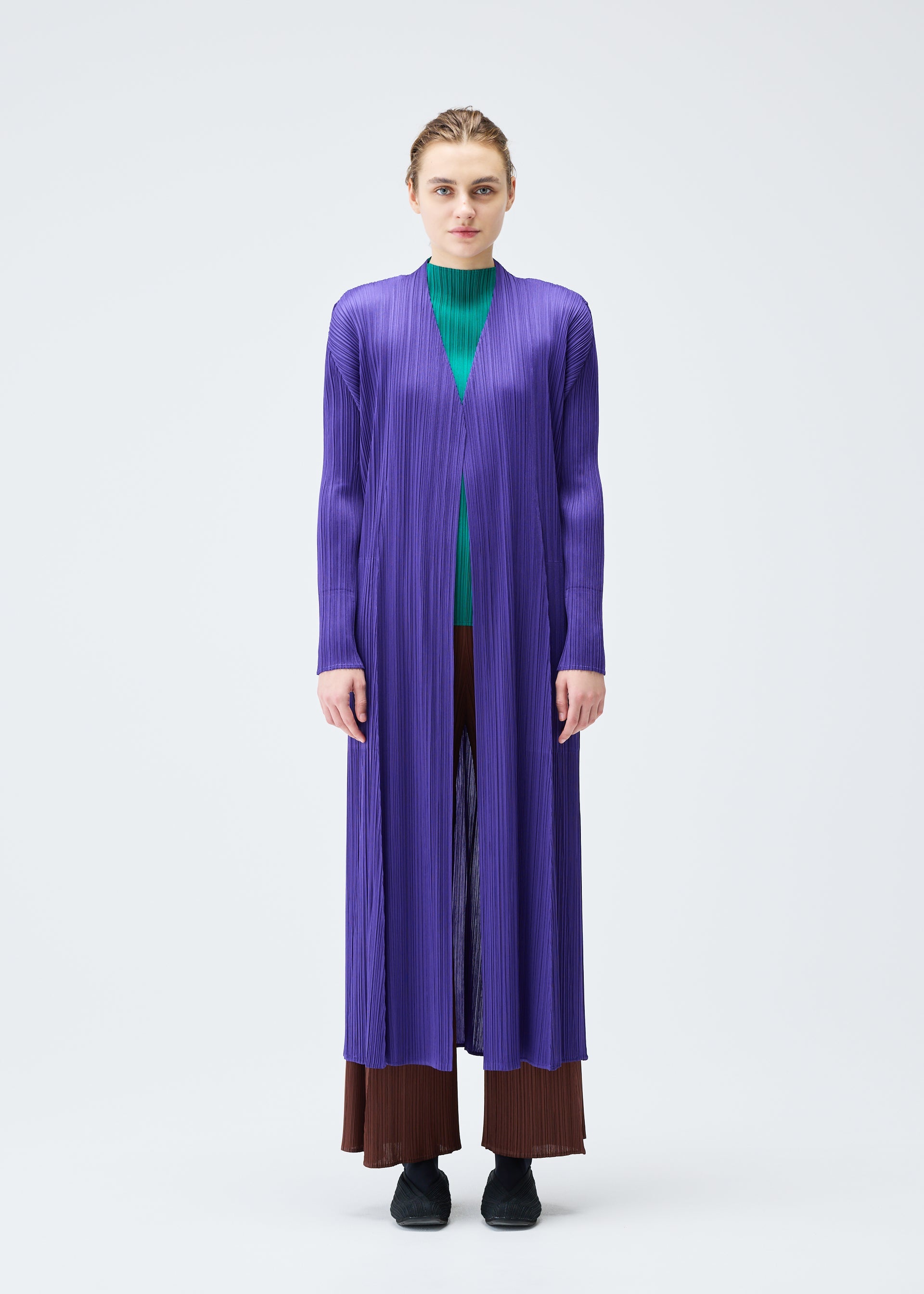 A model wears the PLEATS PLEASE ISSEY MIYAKE MONTHLY COLORS NOVEMBER coat.