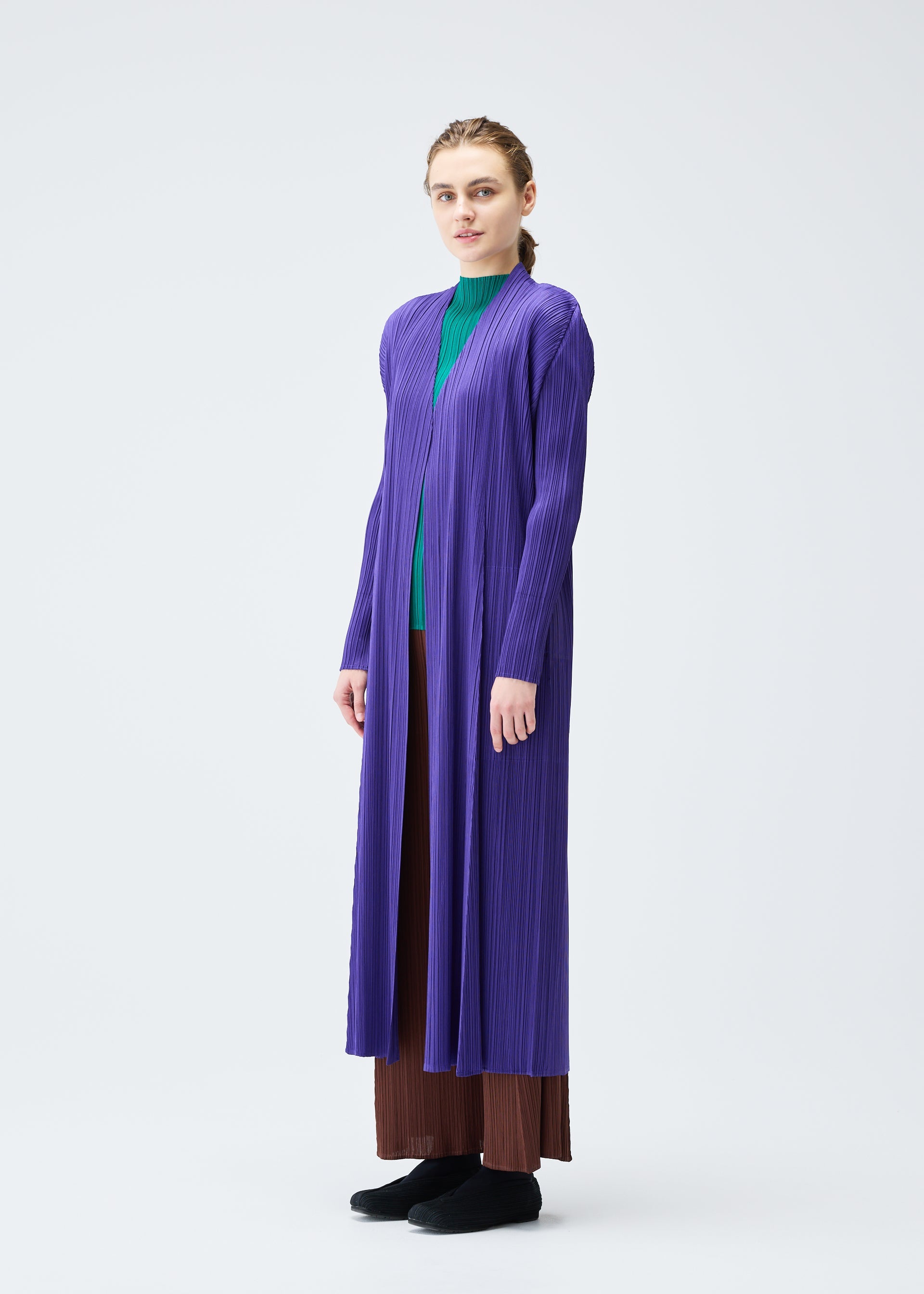 A model wears the PLEATS PLEASE ISSEY MIYAKE MONTHLY COLORS NOVEMBER coat.