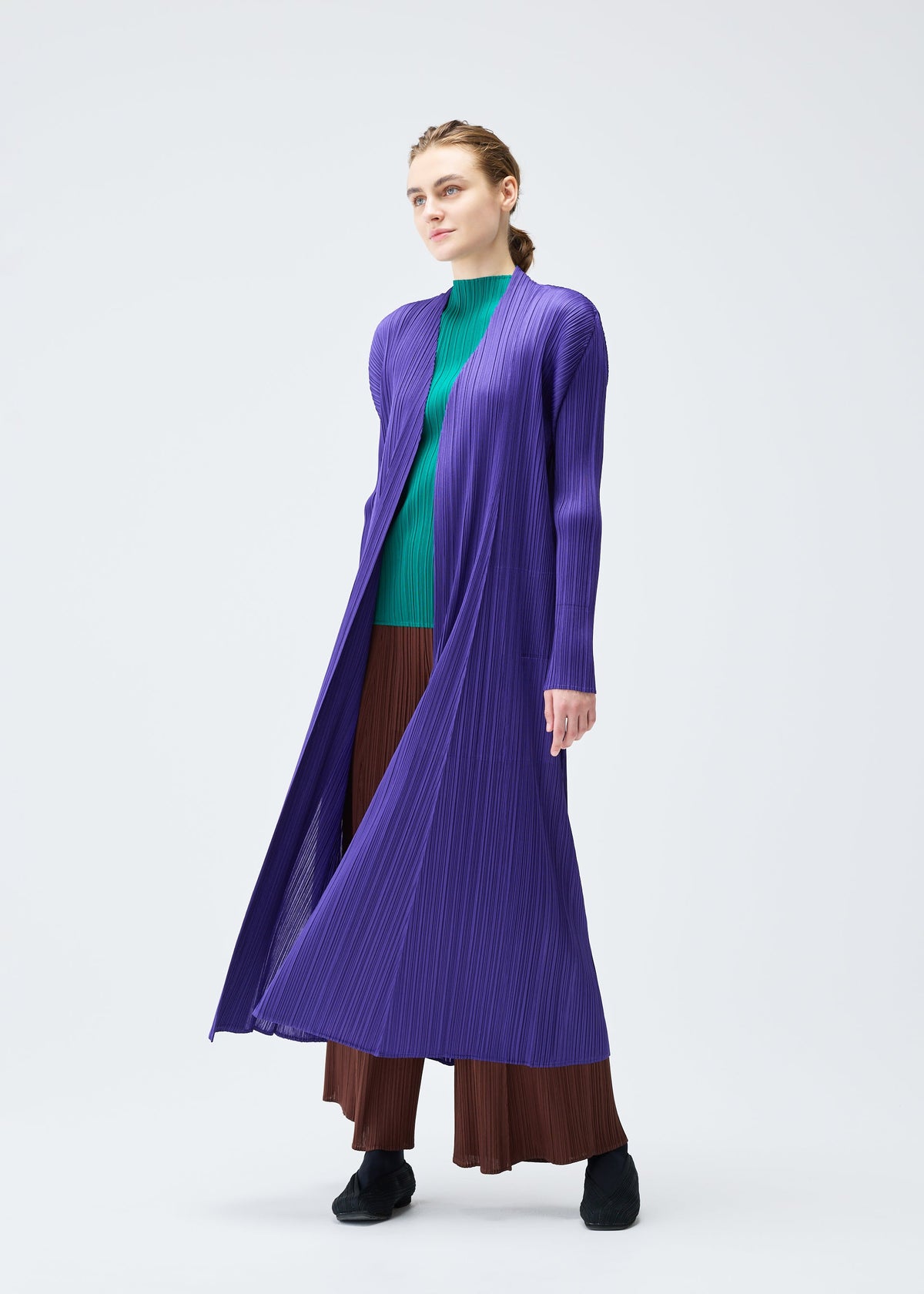A model wears the PLEATS PLEASE ISSEY MIYAKE MONTHLY COLORS NOVEMBER coat.