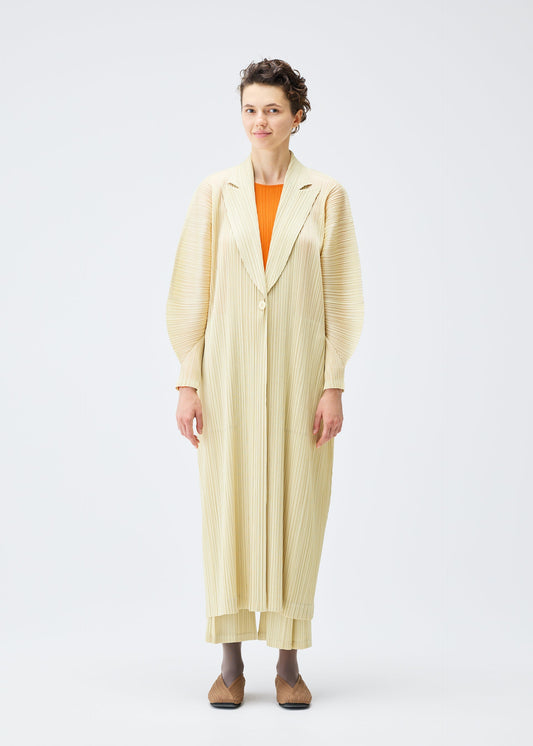 A model wears the PLEATS PLEASE ISSEY MIYAKE MONTHLY COLORS DECEMBER clothing.