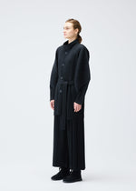 A model wears the PLEATS PLEASE ISSEY MIYAKE WOOL PLEATS coat.