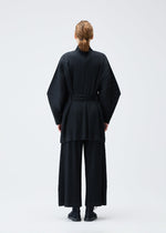 A model wears the PLEATS PLEASE ISSEY MIYAKE WOOL PLEATS coat.