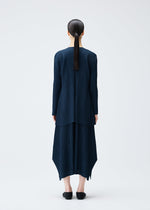 A model wears the PLEATS PLEASE ISSEY MIYAKE MELLOW PLEATS coat.