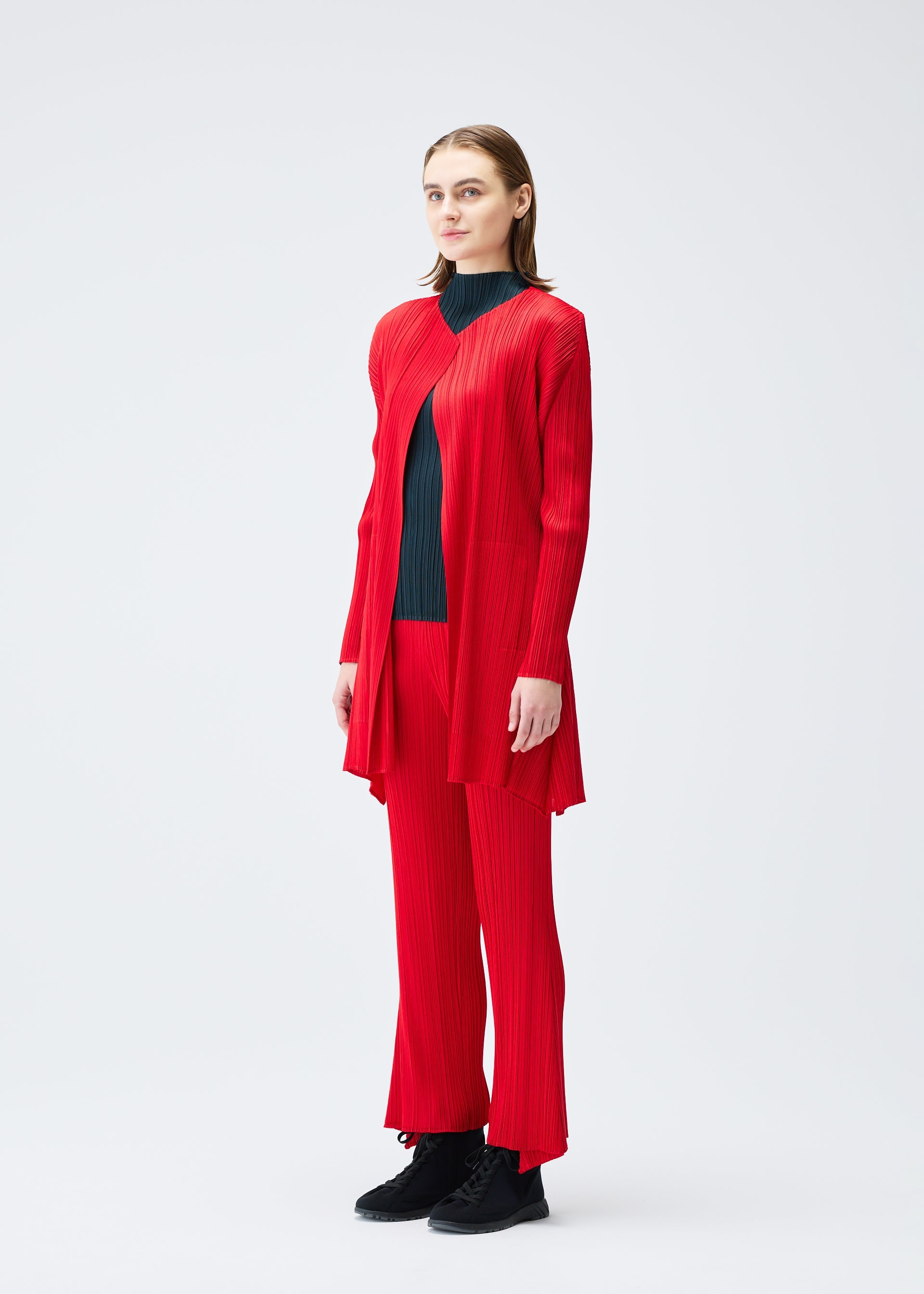 A model wears the PLEATS PLEASE ISSEY MIYAKE OLE! clothing.