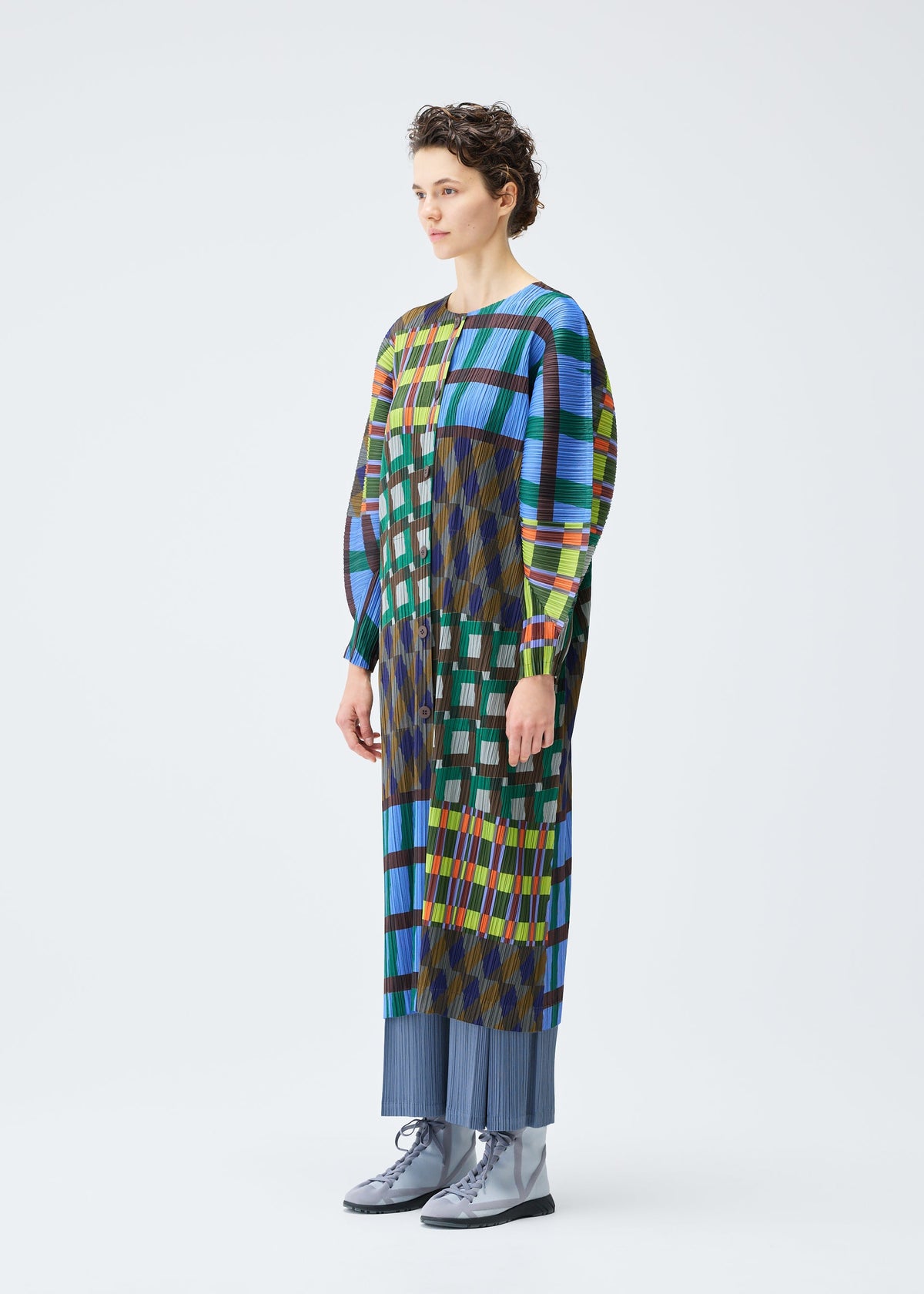 A model wears the PLEATS PLEASE ISSEY MIYAKE HARMONY clothing.