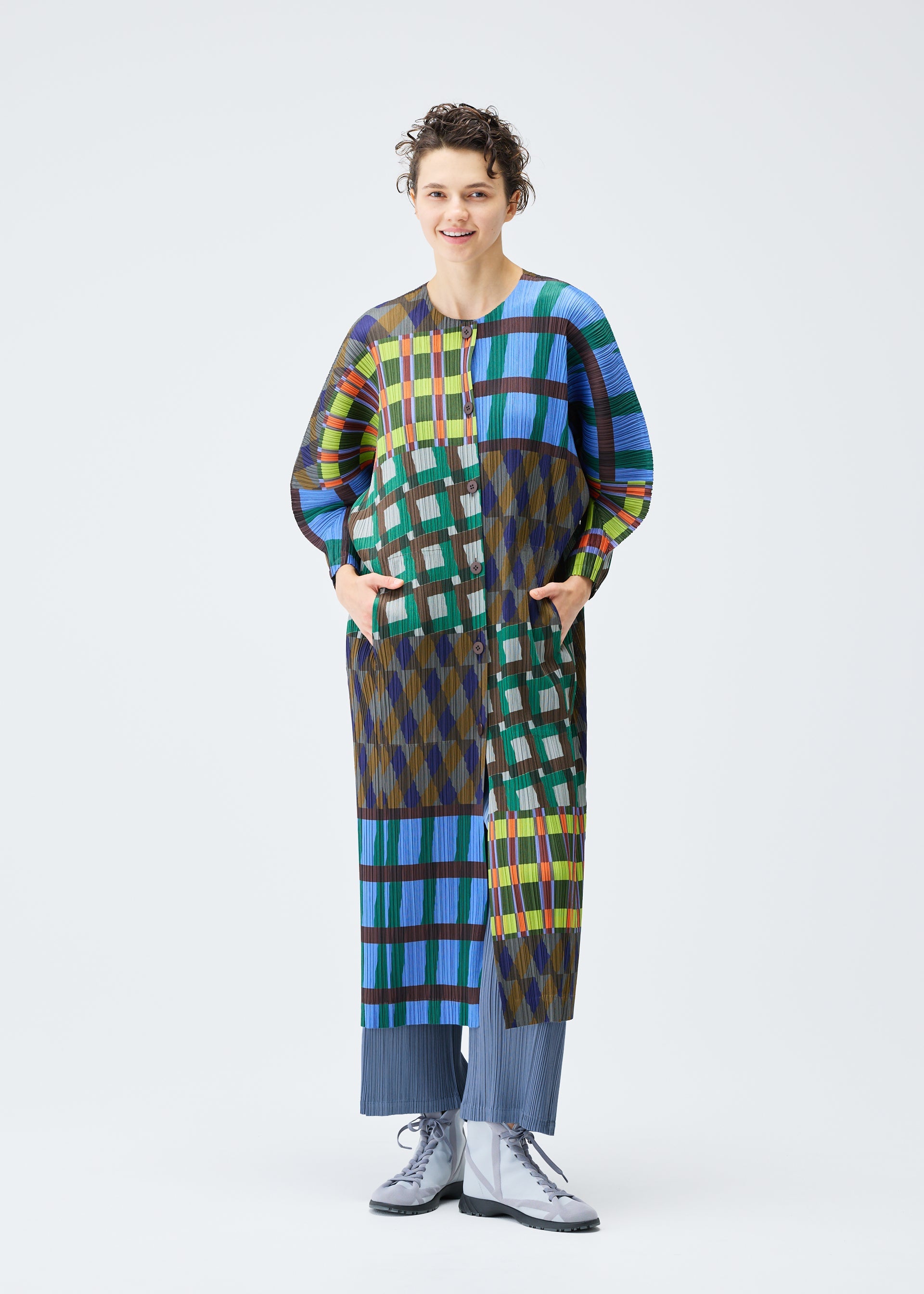 A model wears the PLEATS PLEASE ISSEY MIYAKE HARMONY clothing.