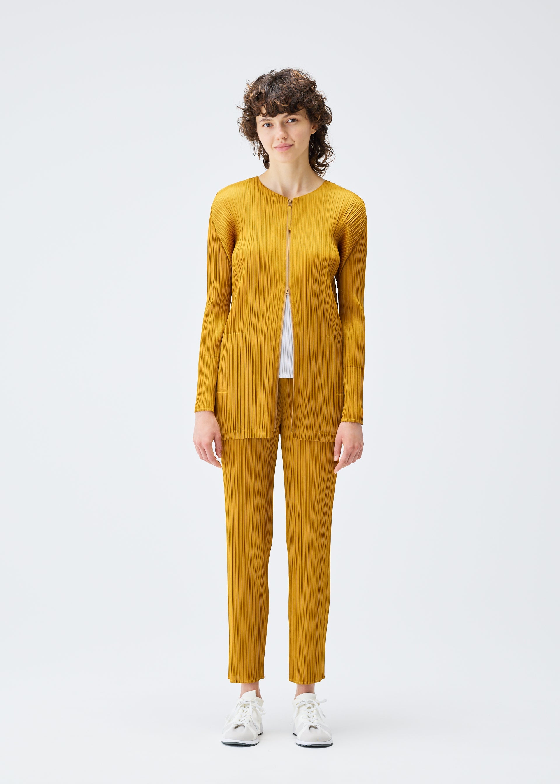 A model wears the PLEATS PLEASE ISSEY MIYAKE MONTHLY COLORS SEPTEMBER jacket.