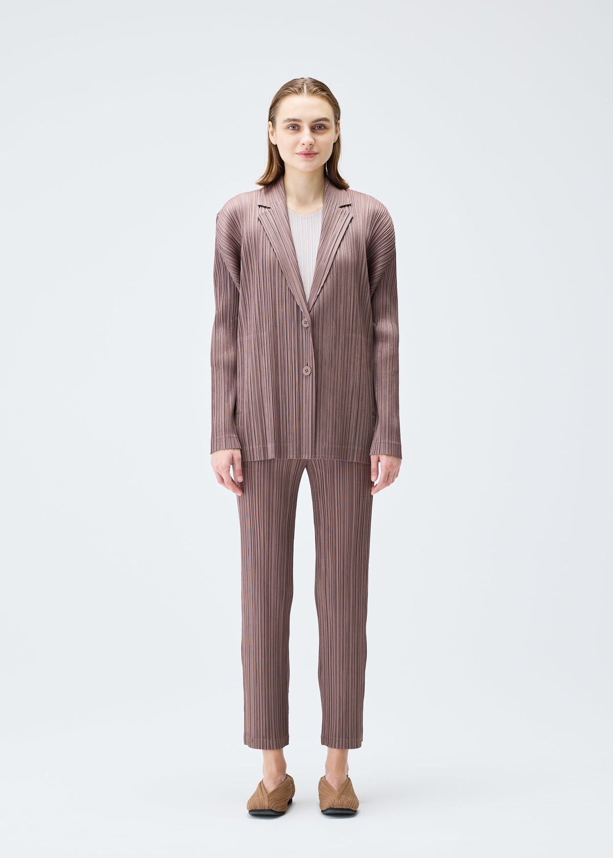 A model wears the PLEATS PLEASE ISSEY MIYAKE PLEATS JACKET jacket.