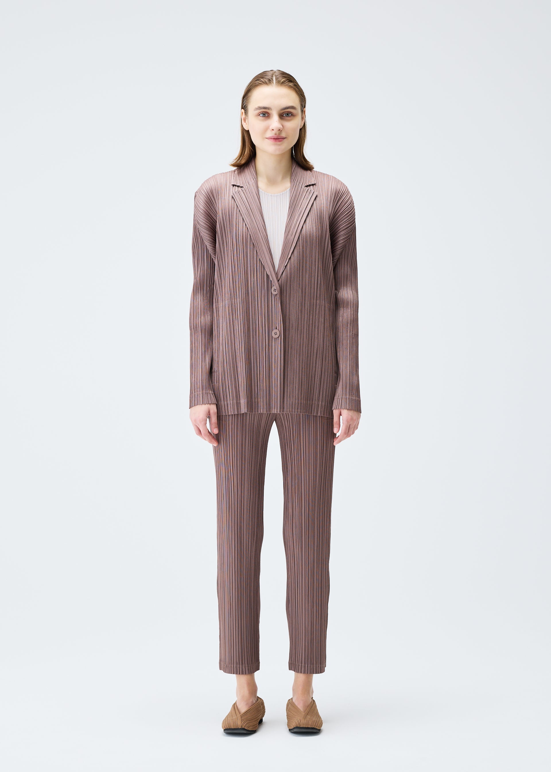 A model wears the PLEATS PLEASE ISSEY MIYAKE PLEATS JACKET jacket.