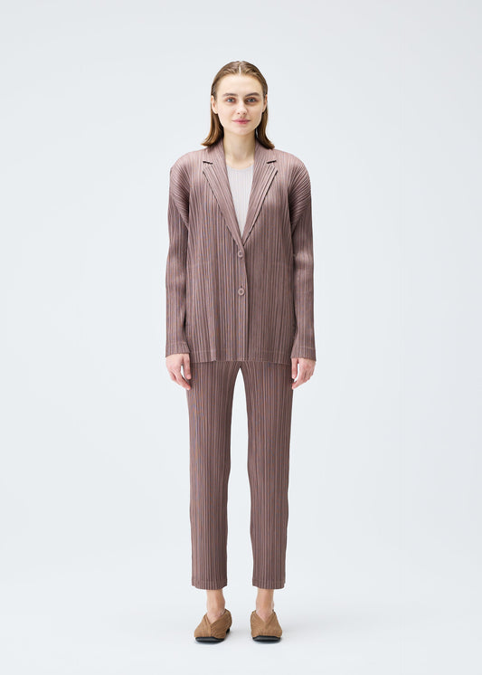 A model wears the PLEATS PLEASE ISSEY MIYAKE PLEATS JACKET jacket.