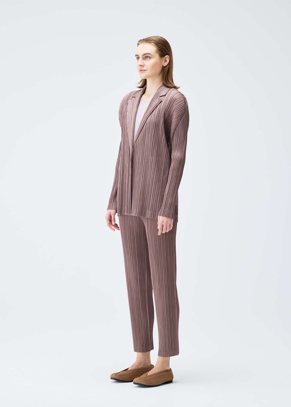 A model wears the PLEATS PLEASE ISSEY MIYAKE PLEATS JACKET jacket.