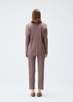 A model wears the PLEATS PLEASE ISSEY MIYAKE PLEATS JACKET jacket.