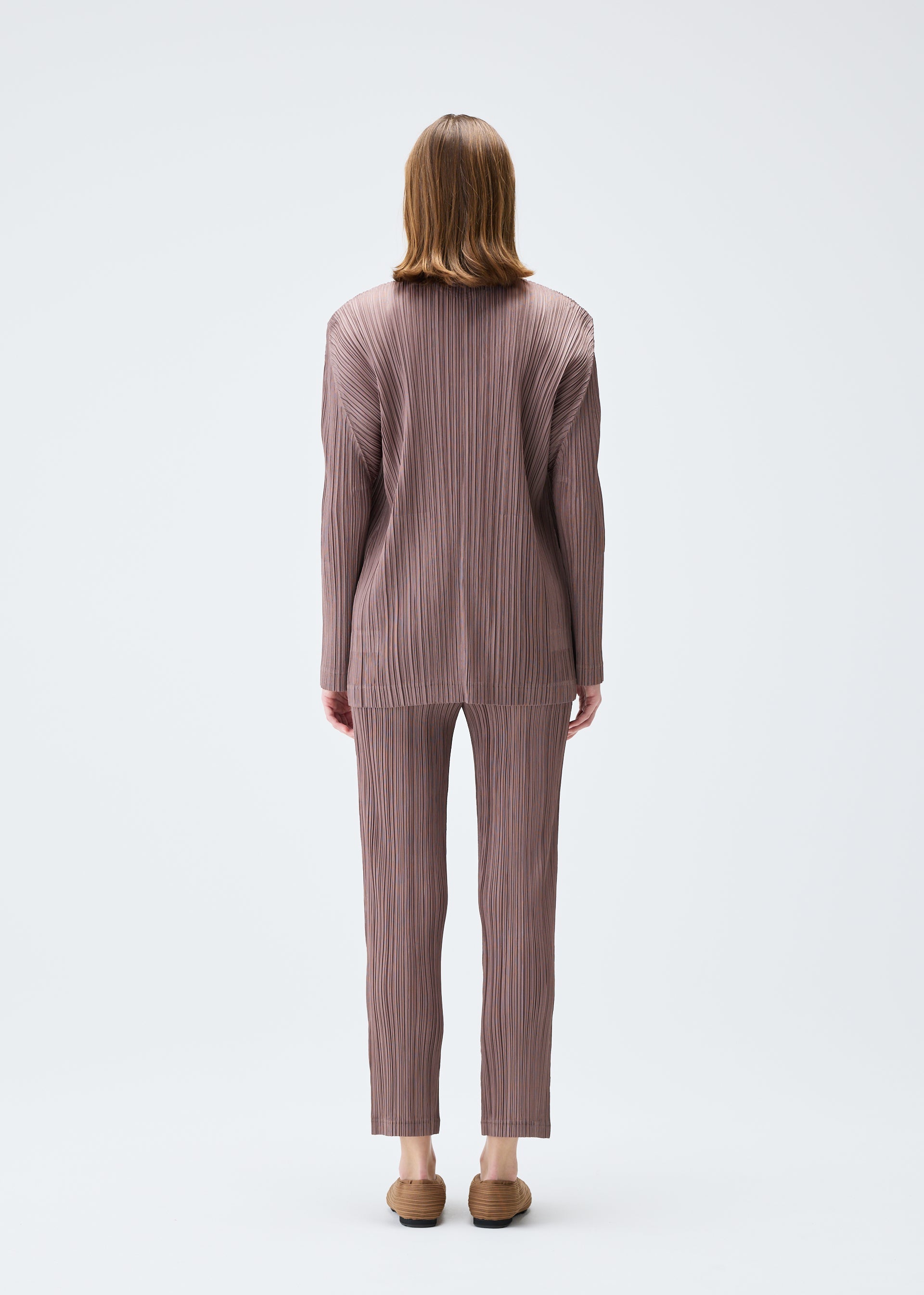 A model wears the PLEATS PLEASE ISSEY MIYAKE PLEATS JACKET jacket.