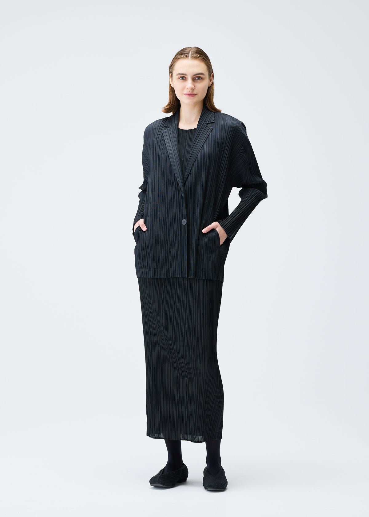 A model wears the PLEATS PLEASE ISSEY MIYAKE PLEATS JACKET jacket.