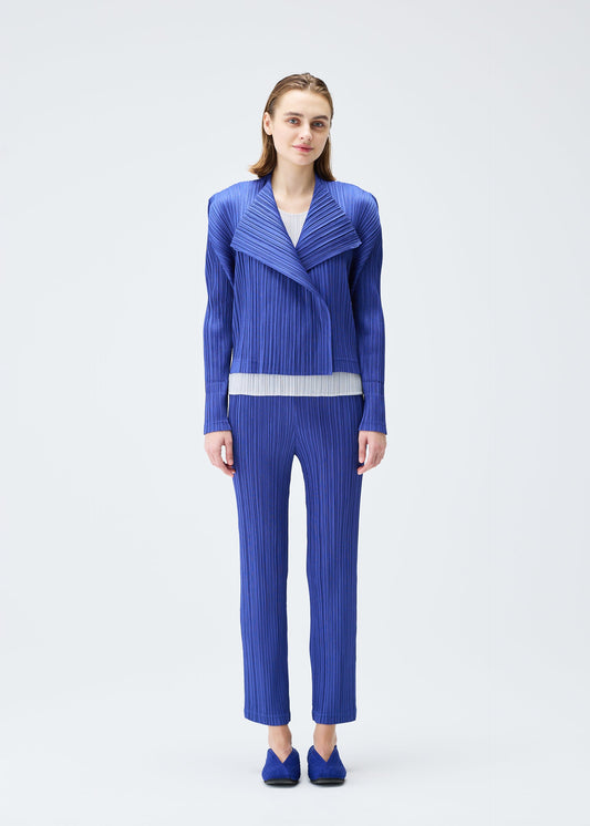 A model wears the PLEATS PLEASE ISSEY MIYAKE PLEATS JACKET jacket.
